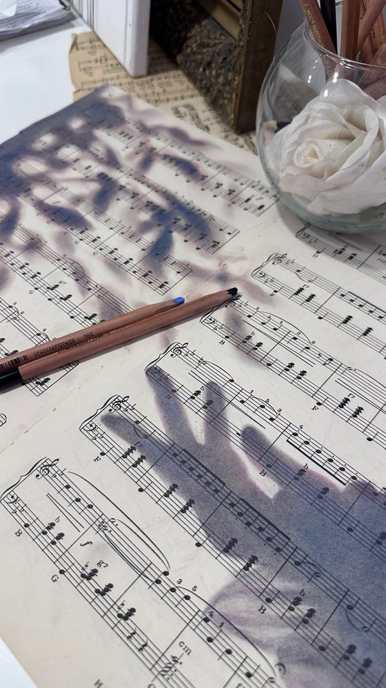 Silhouette Hand And Leaves on Music Sheet