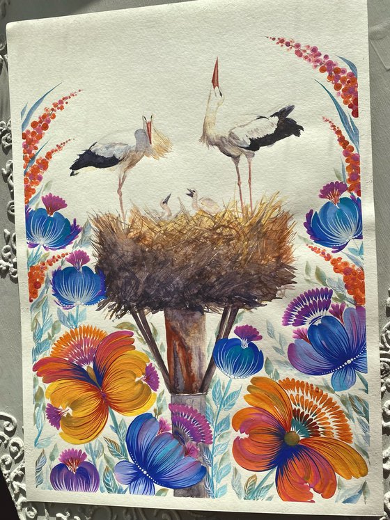 "Nest of Serenity" with a pair of storks in the nest surrounded by a field of lush wild orange, blue flowers