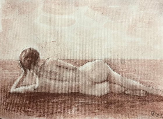 Nude woman from behind lying down on beach
