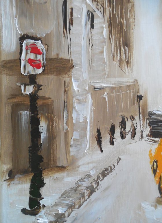 Winter city street with yellow taxi