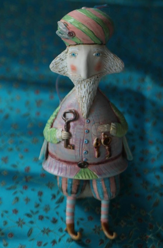 Wise man with the keys. Small ceramic sculpture, bell-doll