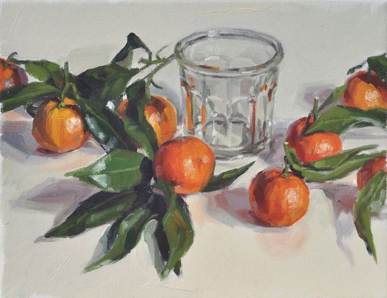 Clementines with leaves and old jam jar