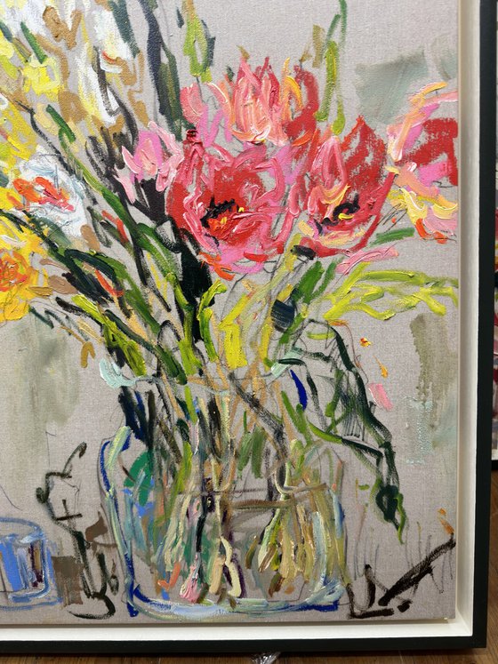 Tulips and daffodils in a glass vase