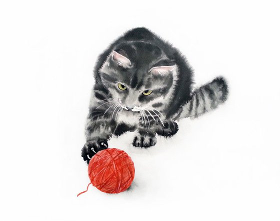 Cat playing with a ball of wool