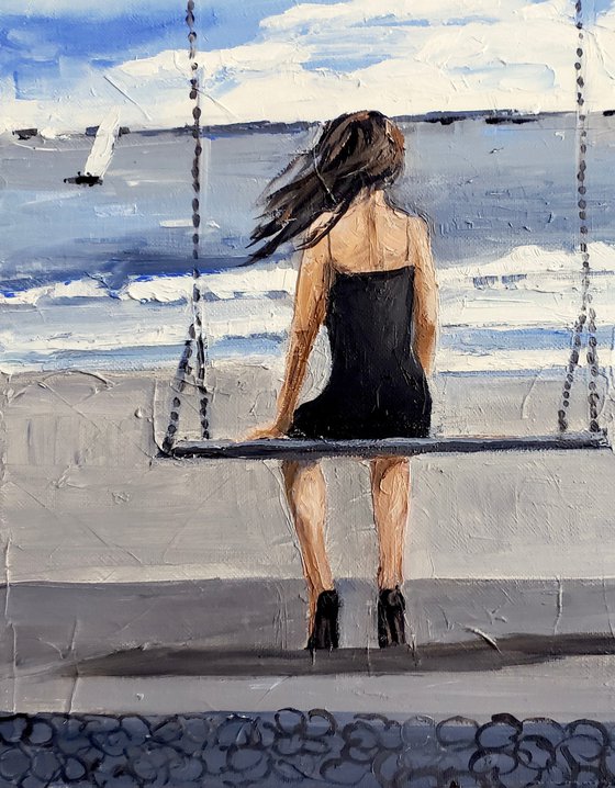 GIRL ON A SWING. WINDY.