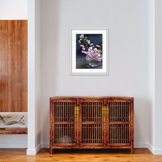 Still life with cherry blossoms in a vase.