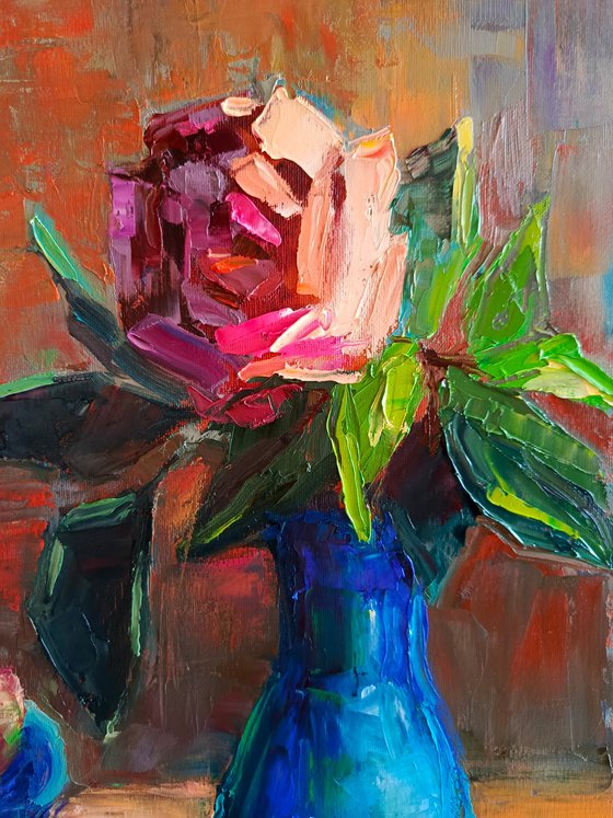 Red rose in a blue vase