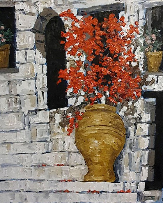 urn of red flowers on steps