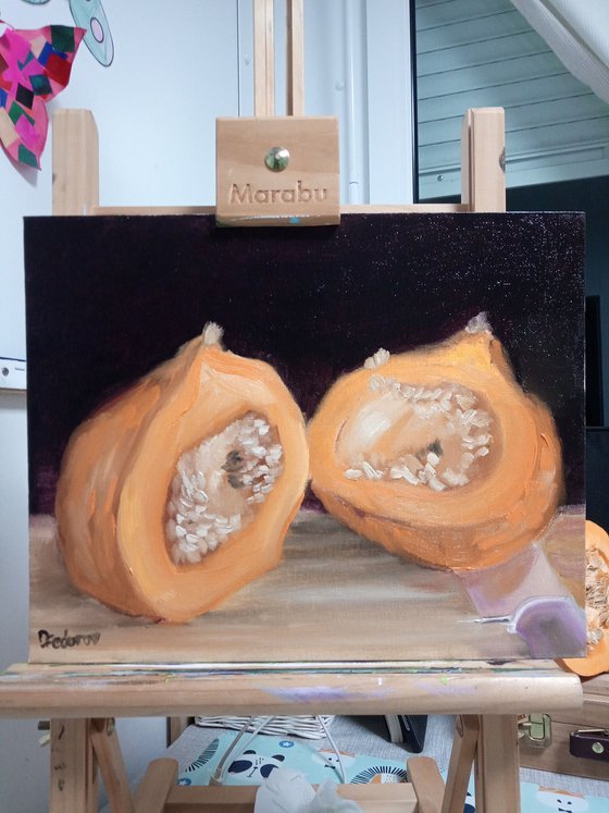 A small pumpkin cut in a half. still life