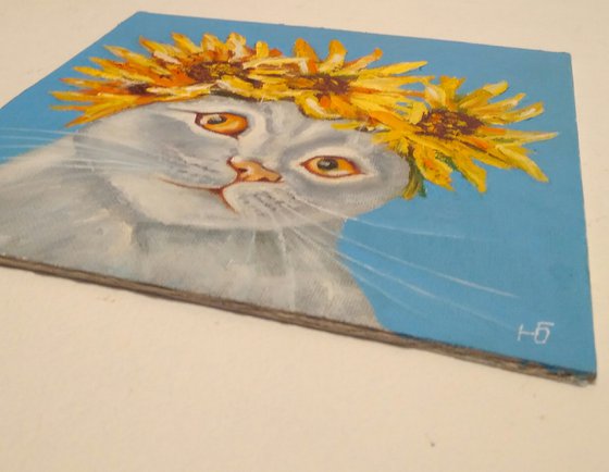 Cat and a wreath of sunflowers