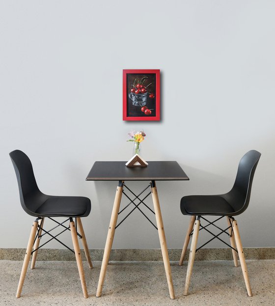 Red cherries in a metal cup