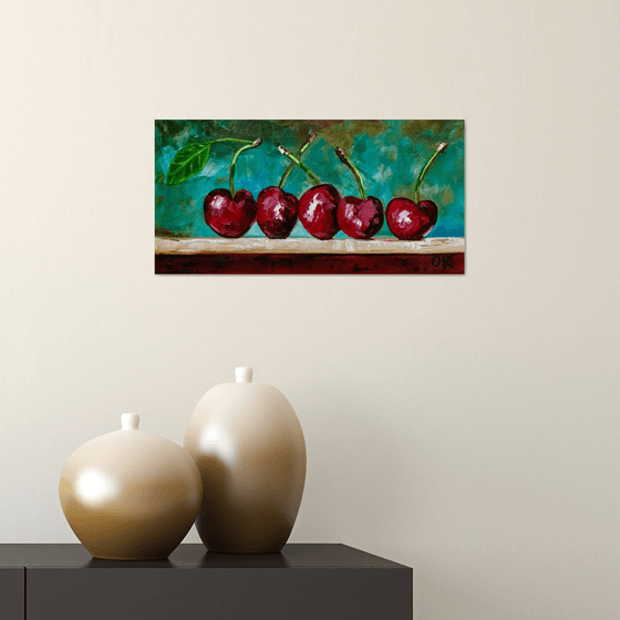 Cherries. Still life on green