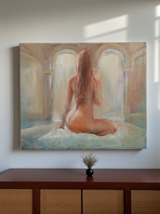 Nude woman seated by the pool
