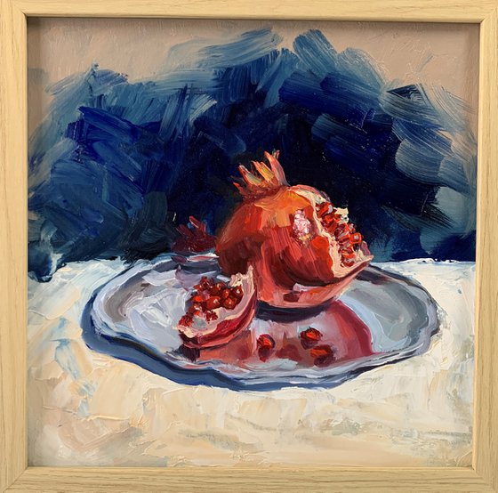 Still life. Pomegranate on silver tray.