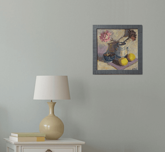 Lemons and flowers with a vase