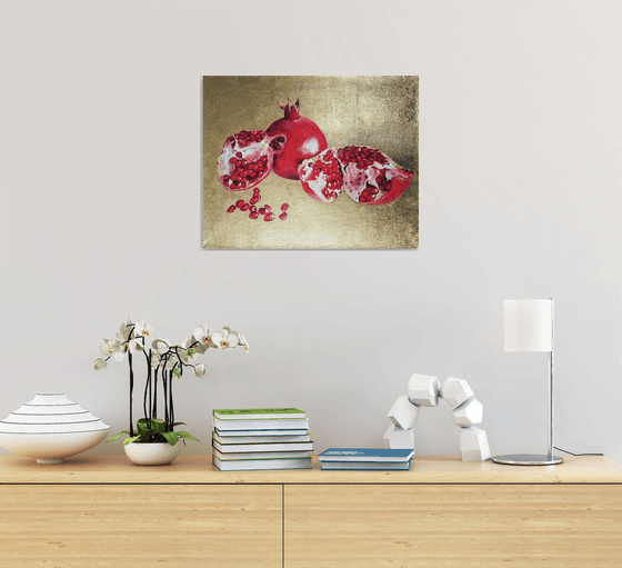 Pomegranate fruit on gold