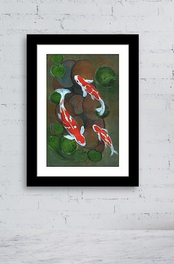 Koi fish in water lily pond