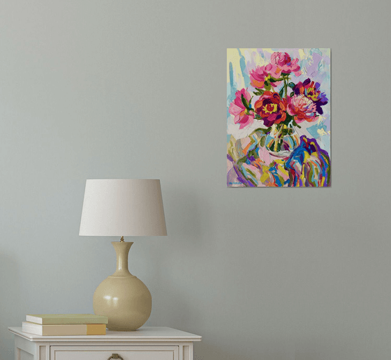 Bright peonies in a glass vase