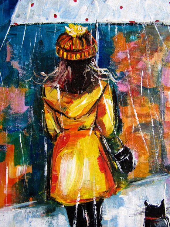 Girl with cat in the rain