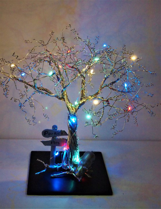 Tree with pig, signpost and lights