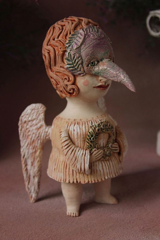 Angel holding a wreath. Ceramic OOAK sculpture.