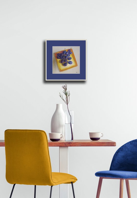 Blue plums on a yellow dish