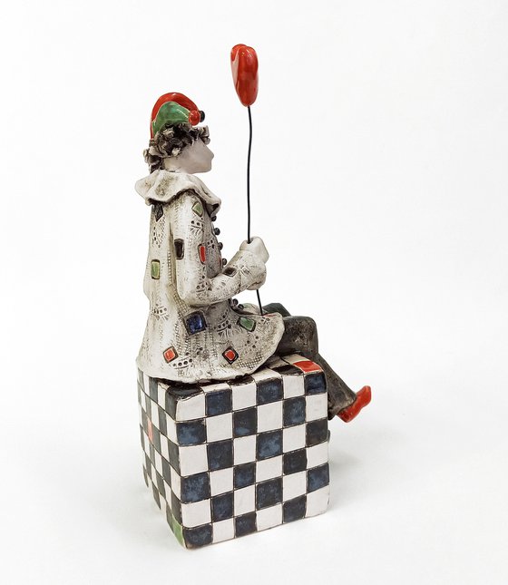 The Clown Sitting on a Chess Cube