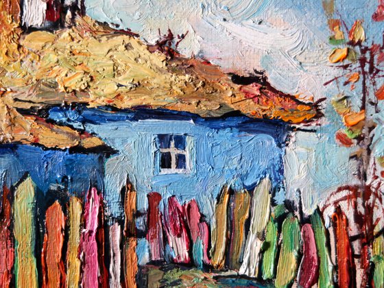 Autumn and the house under a thatched roof.