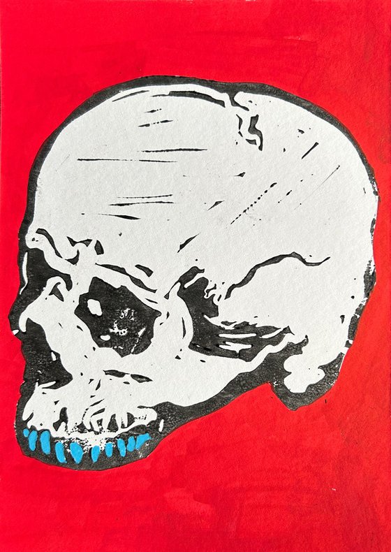 Teeny tiny skull lino print painted red