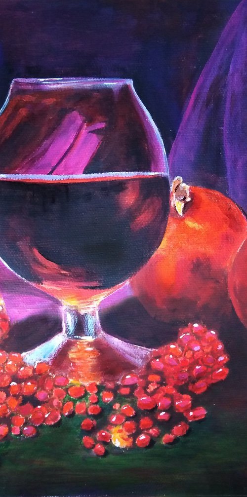 Ripe pomegranate and a glass of wine by Liubov Samoilova