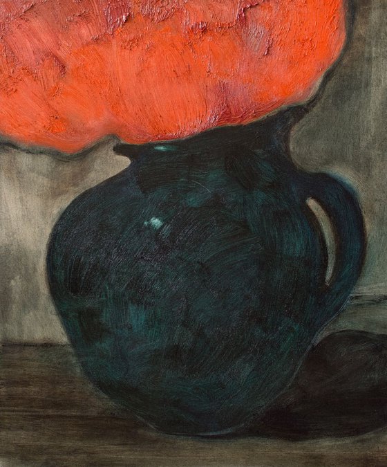The green jug with a red flowers.