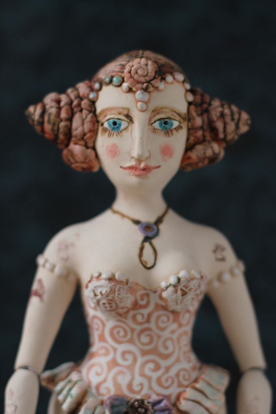 From the Naked clay series, Girl with chignon double bun. Wall sculpture by Elya Yalonetski