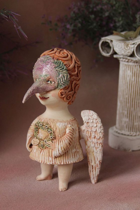 Angel holding a wreath. Ceramic OOAK sculpture.