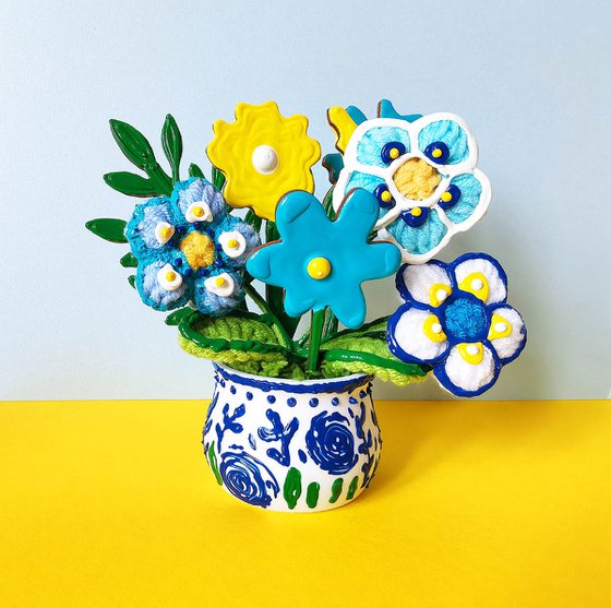 Blue crochet flowers in vase