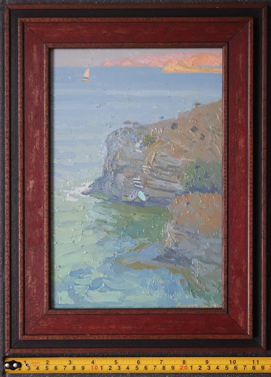 A lonely white sail gleams