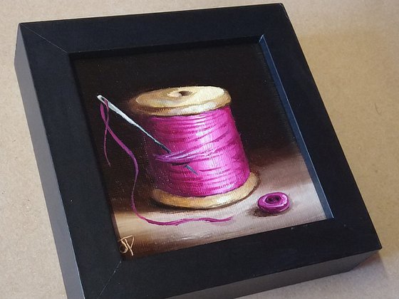 Little pink  cotton reel with button still life