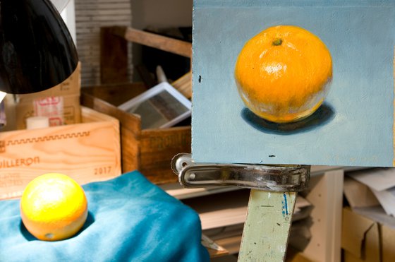 modern still life of perfect orange on blue for fruit lovers