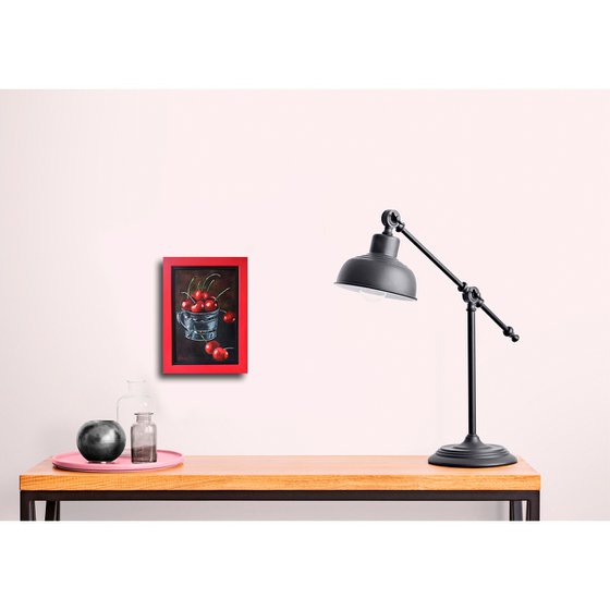 Red cherries in a metal cup