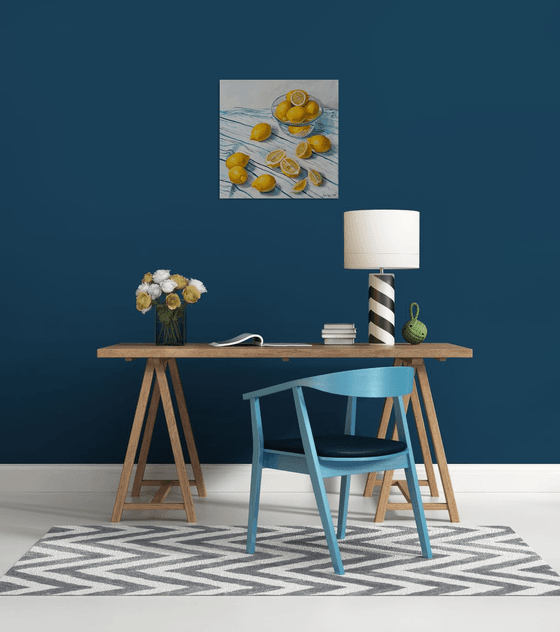 Lemons in glass bowl on stripen tablecloth