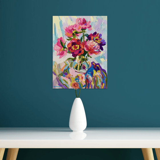 Bright peonies in a glass vase