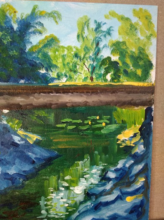 Creek with water lilies under the bridge. Pleinair painting