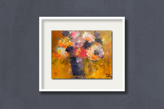 Small still life with bright flowers in the lilac vase on orange background