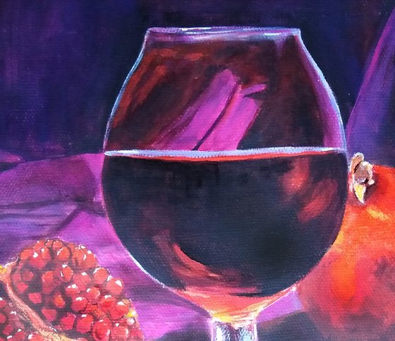 Ripe pomegranate and a glass of wine