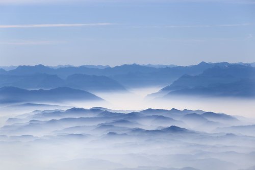 mountains covered with fog by Nikola Lav Ralevic