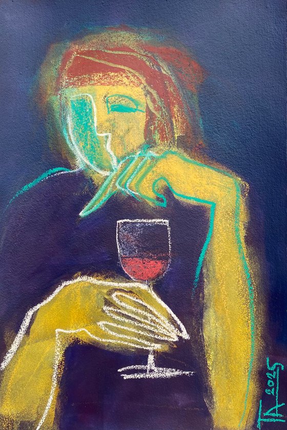 With a glass of red wine.