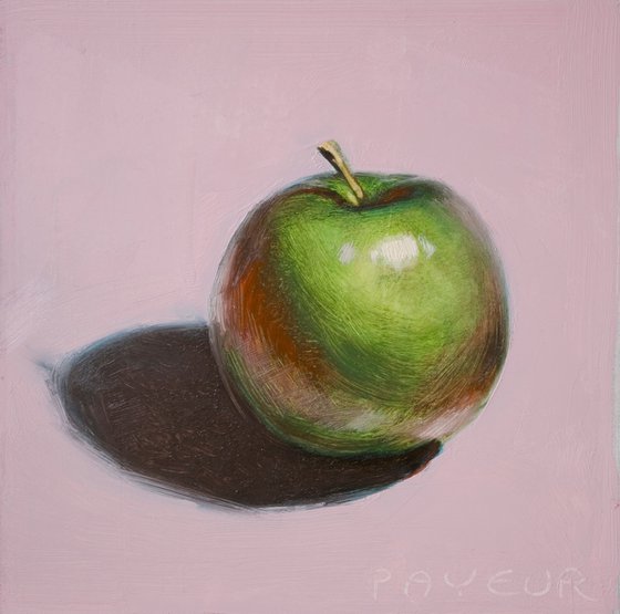 green apple on pink background