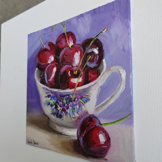 Cherries in porcelain cup