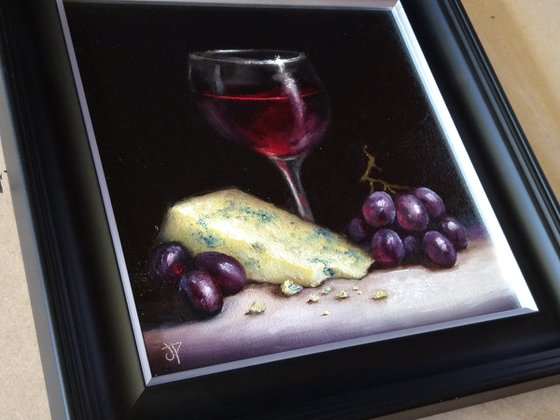 Red wine with cheese and grapes still life