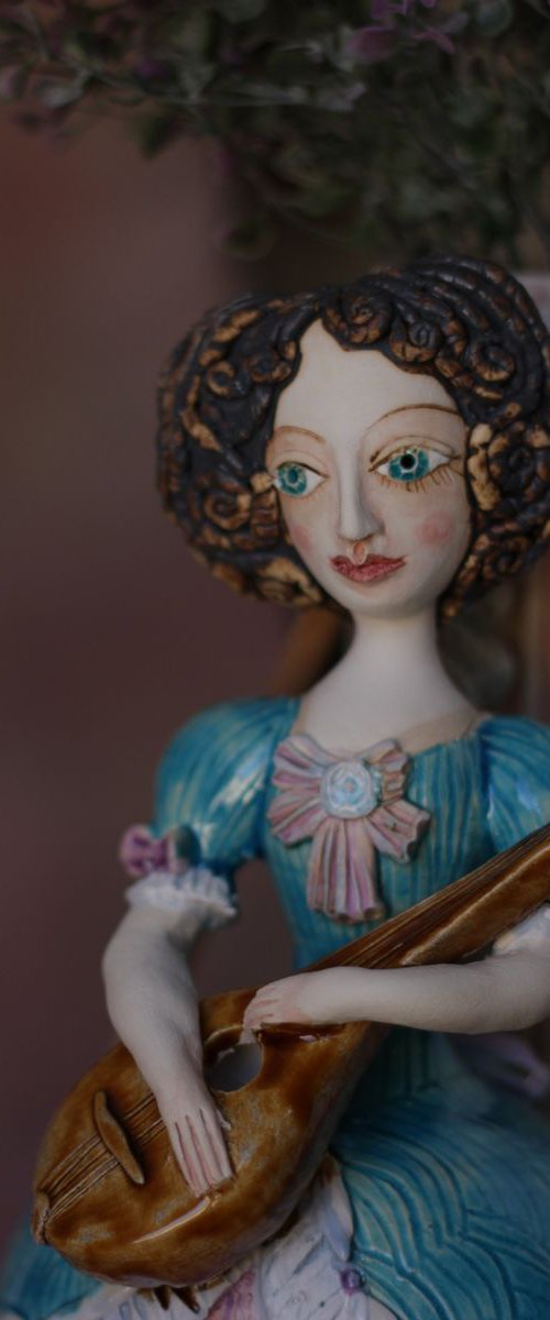 Blue dressed girl with mandolin. Wall ceramic sculpture by Elya Yalonetski. by Elya Yalonetski