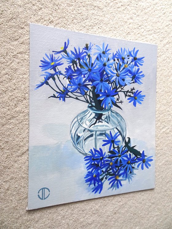 Blue Asters In A Glass Vase